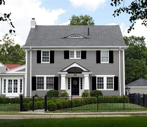 dark gray house with green metal roof|grey houses with black shutters.